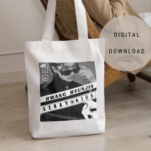 May include: White canvas tote bag featuring a black and white image of a person wearing sunglasses and the text "HWANG HYUNJIN STRAY KIDS everywhere all around the world".