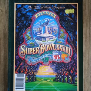 May include: A vintage Super Bowl XXVIII game program. The cover features the Super Bowl logo with the Vince Lombardi Trophy, the Georgia Dome, and the text "The Official Game Program". The program is dated January 30, 1994.