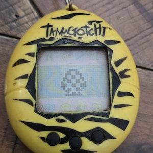 Virtual Pet , Original TAMAGOTCHI YELLOW TIGER ~ 1997 90's pop culture, powers on image 1