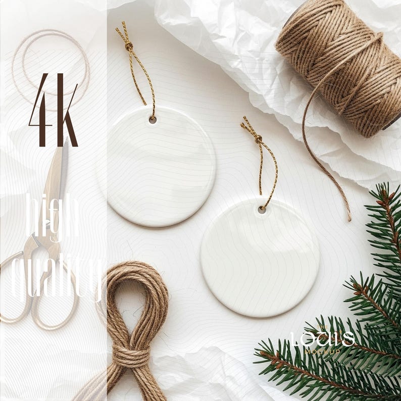 May include: Two white ceramic round ornaments with gold string hangers. The ornaments are on a white surface with twine, scissors, and a sprig of evergreen. The image has the text "4K High Quality".