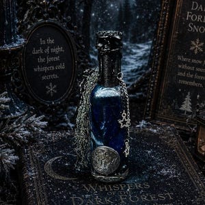 May include: A blue glass bottle with a black wax-sealed top, adorned with a silver star charm and a metallic circular emblem. The bottle rests on a dark book titled Whispers of the Dark Forest, surrounded by candles and framed text signs.