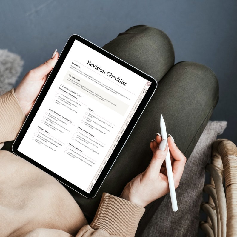 May include: A digital tablet displaying a "Revision Checklist" document. The tablet is held by a person, with a stylus in the other hand. The document includes sections for overview, instructions, and revision checklist items. The person is wearing a beige sweater and olive green pants.