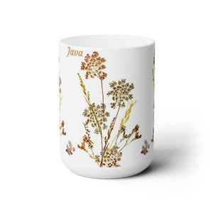May include: White ceramic mug with a floral design featuring brown and yellow dried flowers. The word "Java" is printed on the mug.