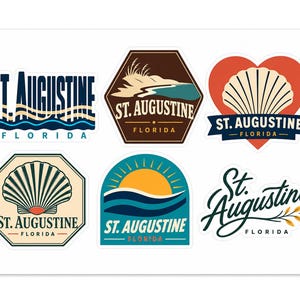 May include: A collection of six vinyl stickers featuring St. Augustine, Florida themes. Designs include text-based logos, a beach landscape, a seashell inside a heart, a seashell in an octagon, a sunrise over waves, and a script font logo with leaves.