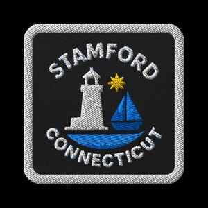 May include: Embroidered patch featuring the text "STAMFORD CONNECTICUT" in white. The design includes a white lighthouse, a yellow star, and a blue sailboat on a black background, framed by a white border.
