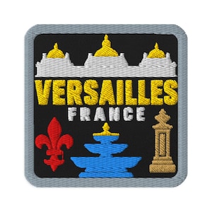May include: A square embroidered patch with a black background and a grey border. It features a white and gold building silhouette, the yellow text VERSAILLES, white text FRANCE, a red fleur-de-lis, a blue tiered fountain, and a gold pillar.