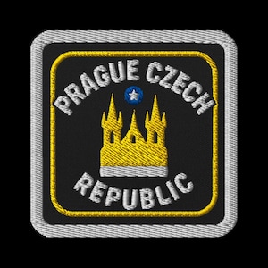 May include: Embroidered patch featuring the text "PRAGUE CZECH REPUBLIC" in white lettering. The patch has a black background with a yellow border and a gold castle illustration. A blue star is above the castle.