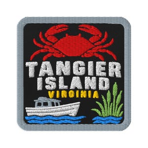 May include: A square embroidered patch with a gray border on a black background. It features a red crab at the top, the white text TANGIER ISLAND, the yellow text VIRGINIA, a white boat on blue water, and green marsh grass on the bottom right.