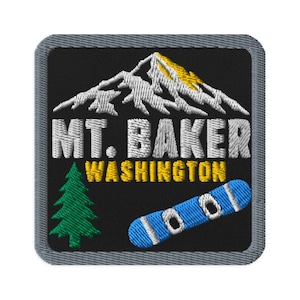 May include: A square embroidered patch with a black background and a grey border. It features a white and yellow mountain peak, the text MT. BAKER WASHINGTON in white and yellow, a green pine tree, and a blue and white snowboard graphic.