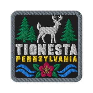 May include: A square embroidered patch with a black background featuring a white deer silhouette, two green pine trees, and blue wavy lines. The text TIONESTA is in white, and PENNSYLVANIA is in yellow, with a pink flower at the bottom center.