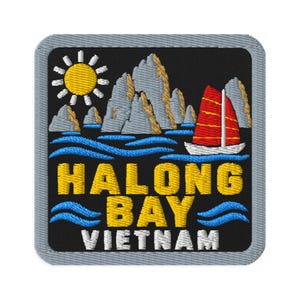May include: A square embroidered patch with a black background featuring a yellow sun, grey limestone karsts, and a red-sailed boat on blue waves. The text HALONG BAY is embroidered in yellow, with the word VIETNAM in white below the waves.