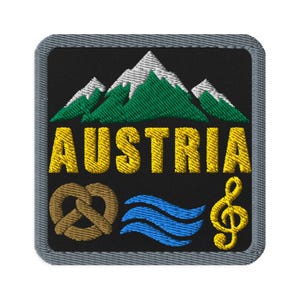 May include: A square embroidered patch with a black background and a gray border. It features green and white mountains above the yellow text AUSTRIA. Below the text are a brown pretzel, three blue wavy lines, and a yellow treble clef symbol.