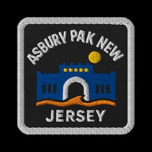 May include: Embroidered patch featuring the words "ASBURY PARK NEW JERSEY" in white. The design includes a blue building with an archway, a yellow sun, and an orange wave. The patch has a black background and a white border.