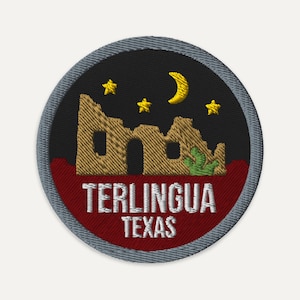 May include: A circular embroidered patch featuring a black night sky with a yellow crescent moon and three stars above a tan stone ruin and a green cactus. The bottom section is dark red with the white text TERLINGUA TEXAS.