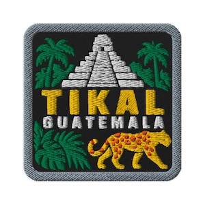 May include: A square embroidered patch with a black background featuring a white Mayan pyramid, green palm trees, and a yellow jaguar with red spots. The text TIKAL is in yellow and GUATEMALA is in white. The patch has a gray stitched border.