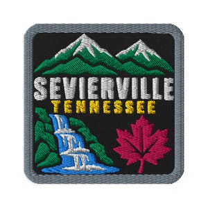 May include: A square embroidered patch with a black background and a gray border. It features green mountains with white snow-capped peaks, a blue waterfall, a red maple leaf, and the text SEVIERVILLE in white and TENNESSEE in yellow.