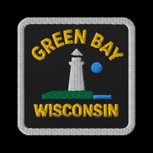 May include: A white ceramic mug with a black handle and the text "But First, Coffee" in a bold, black font. The mug is set against a blurred background, suggesting a cozy setting.