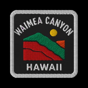 May include: Embroidered patch featuring the words "WAIMEA CANYON HAWAII" in white. The design includes a red and green mountain range, a yellow sun, and a black background, all within a square frame with a silver border.