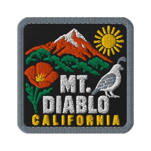 May include: A square embroidered patch with a black background and a grey border. It features a snow-capped orange mountain, a yellow sun, a green forest, an orange poppy, and a grey quail. The text reads MT. DIABLO CALIFORNIA in white and yellow.