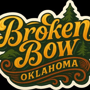 May include: A sticker with the words "Broken Bow Oklahoma" in a vintage style. The text is in gold and white, set against a dark green background with illustrations of trees and mountains. The sticker has a cream-colored border.