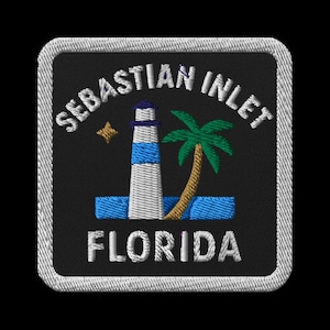 May include: Embroidered patch featuring a lighthouse with blue stripes, a palm tree, and a star on a black background. The text "Sebastian Inlet Florida" is embroidered in white, with a white border.