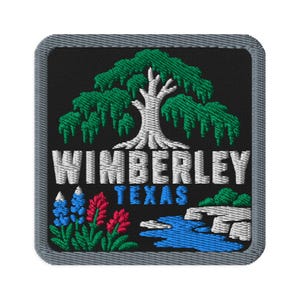 May include: A square embroidered patch with a black background and a gray border. It features a white tree with green foliage, the white text WIMBERLEY, blue text TEXAS, blue and red flowers, and a blue stream flowing past white rocks.