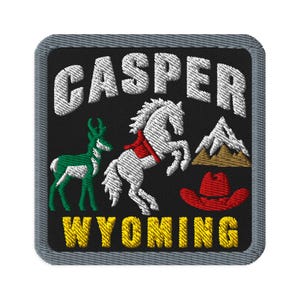 May include: A square embroidered patch with a black background and a gray border. It features the white text CASPER above a green pronghorn, a white rearing horse with a red saddle, a mountain range, and a red cowboy hat, with WYOMING in yellow.