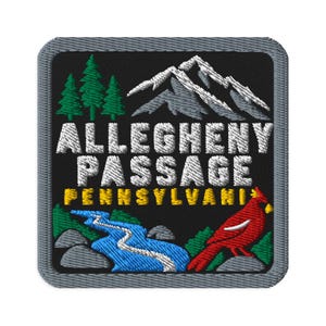 May include: A square embroidered patch with a black background featuring a white mountain range, green pine trees, a blue river, and a red cardinal bird. The text reads ALLEGHENY PASSAGE in white and PENNSYLVANIA in yellow with a grey border.
