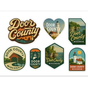 May include: A collection of Door County, Wisconsin stickers in various shapes. Designs include a lighthouse, a covered bridge, and scenic landscapes. The stickers feature text such as "Door County" and "Wisconsin" in a vintage style.