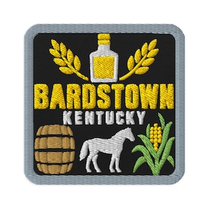 May include: A square embroidered patch with a gray border on a black background. It features a yellow bottle flanked by wheat stalks, the yellow text BARDSTOWN, white text KENTUCKY, a brown wooden barrel, a white horse, and a green corn stalk.