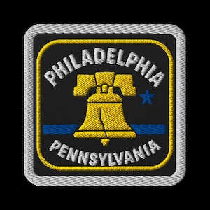 May include: Embroidered patch featuring the Liberty Bell in yellow, with the words "PHILADELPHIA" and "PENNSYLVANIA" in white. A blue star and blue stripes are also included on the black background, with a white border.