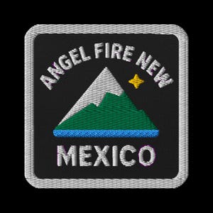 May include: Embroidered patch featuring the words "ANGEL FIRE NEW MEXICO" in white, arched around the top of a black square. The design includes a mountain range in white and green, a blue line, and a yellow star.