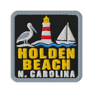 May include: A square embroidered patch with a grey border on a black background. It features a white pelican, a red and white lighthouse, and a white sailboat above blue waves. The text reads HOLDEN BEACH in yellow and N. CAROLINA in white.
