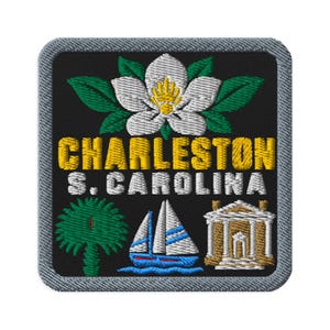 May include: A square embroidered patch with a black background and a grey border. It features a white magnolia flower with green leaves, the yellow text "CHARLESTON", white text "S. CAROLINA", a green palmetto tree, a sailboat, and a building.