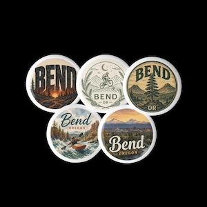 May include: Five circular stickers featuring illustrations of Bend, Oregon. Designs include a sunset forest, a mountain biker, a pine tree landscape, a person kayaking on a river, and a panoramic view of snow-capped mountains above a town.