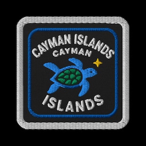 Puede incluir: Parche bordado con el texto "CAYMAN ISLANDS" en blanco, arqueado alrededor de un cuadrado azul. Una tortuga marina azul con caparazón verde y una estrella amarilla están en el centro. El parche tiene un fondo negro y un borde plateado.