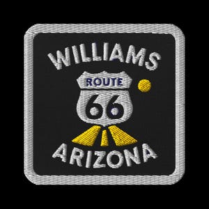 May include: Embroidered patch featuring the words "WILLIAMS ARIZONA" and "ROUTE 66" in white lettering. The design includes a Route 66 shield with the number 66. The patch has a black background and a white border.