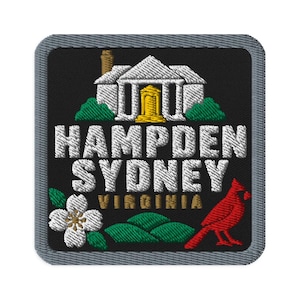 May include: A square embroidered patch with a black background and a gray border. It features a white building with a gold door, green bushes, a white dogwood flower, a red cardinal, and the white text HAMPDEN SYDNEY with VIRGINIA in gold.