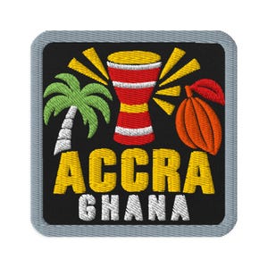 May include: A square embroidered patch with a black background featuring a green palm tree, a red and yellow djembe drum, and an orange cocoa pod. The text ACCRA is embroidered in yellow and GHANA is embroidered in white at the bottom.