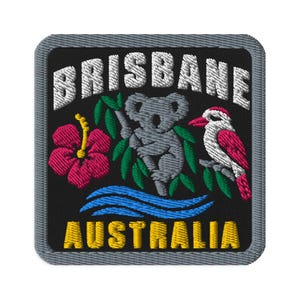 May include: A square embroidered patch with a black background and a gray border. It features the white text BRISBANE at the top, a gray koala, a pink hibiscus flower, a kookaburra, blue waves, and the yellow text AUSTRALIA at the bottom.