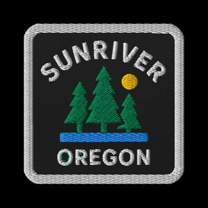 May include: Embroidered patch with the words "SUNRIVER OREGON" in white, arched across the top and bottom. The design features three green pine trees, a yellow sun, and a blue river on a black background, framed by a white border.
