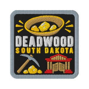 May include: A square embroidered patch with a gray border on a black background. It features a gold mining pan with gold nuggets, a pickaxe, and a saloon building. The text reads DEADWOOD SOUTH DAKOTA in white and yellow block lettering.