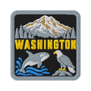 May include: A square embroidered patch with a gray border featuring a black background. It displays a snow-capped mountain, a forest of pine trees, the yellow text WASHINGTON, a gray orca jumping in blue water, and a bald eagle perched on a rock.