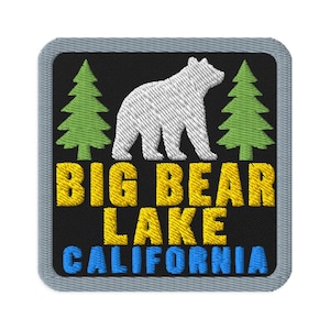 May include: A square embroidered patch with a black background featuring a white bear silhouette flanked by two green pine trees. The text BIG BEAR LAKE is stitched in yellow, and the word CALIFORNIA is stitched in light blue below it.