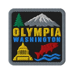May include: A square embroidered patch with a gray border on a black background. It features a green pine tree, a white snow-capped mountain, a yellow capitol building, and a red fish above blue waves. The text OLYMPIA WASHINGTON is embroidered.