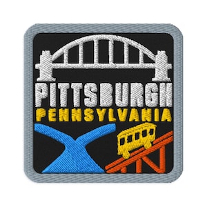 May include: A square embroidered patch with a gray border on a black background. It features a white arched bridge, the white text PITTSBURGH, the yellow text PENNSYLVANIA, a blue river junction, and a yellow funicular on orange tracks.