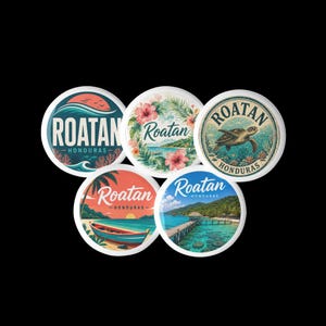 May include: Five circular coasters featuring illustrations of Roatan, Honduras. Designs include a sunset wave, tropical hibiscus flowers, a sea turtle, a beach with a boat, and a wooden pier over turquoise water, all labeled with Roatan Honduras text.