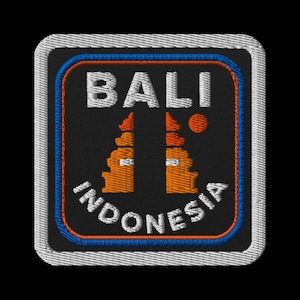 May include: Embroidered patch featuring the word "BALI" in white, above "INDONESIA" in white, with orange and black imagery. The patch has a black background, a blue and orange border, and a white stitched edge.