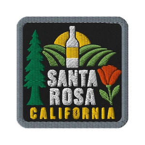 May include: A square embroidered patch with a black background and a gray border. It features a green pine tree, a yellow sun, a white wine bottle, green hills, and an orange poppy. The text reads SANTA ROSA CALIFORNIA in white and yellow.