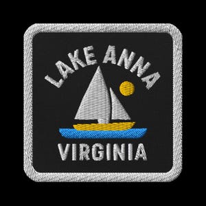 May include: Embroidered patch featuring a sailboat on Lake Anna, Virginia. The design includes a white sailboat with a yellow hull, a blue water line, and a yellow sun. The text "LAKE ANNA VIRGINIA" is embroidered in white.